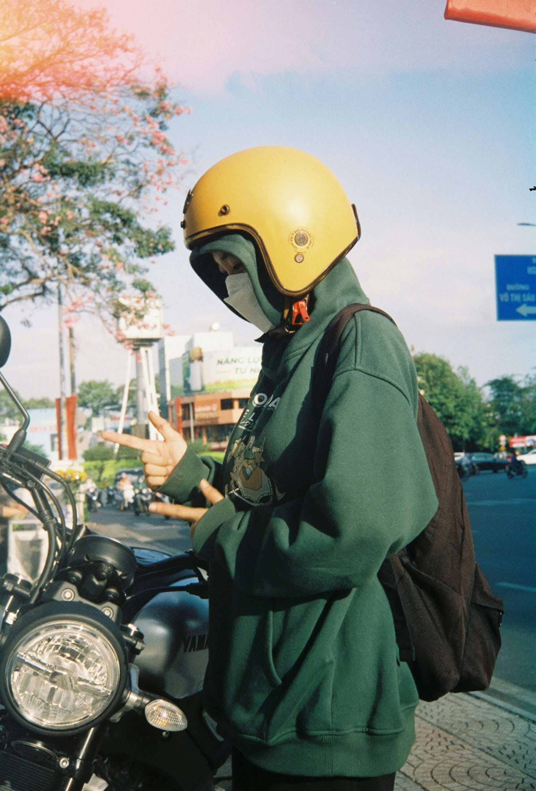 Motorcyclist wearing hearing protection earplugs before putting on helmet